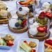 Elegant display of desserts and hors d'oeuvres featuring fresh fruits and pastry bites.